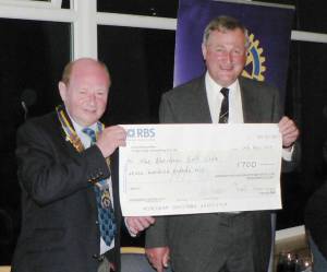 Golf Club captain David Erskine (right) receives cheque for £700
